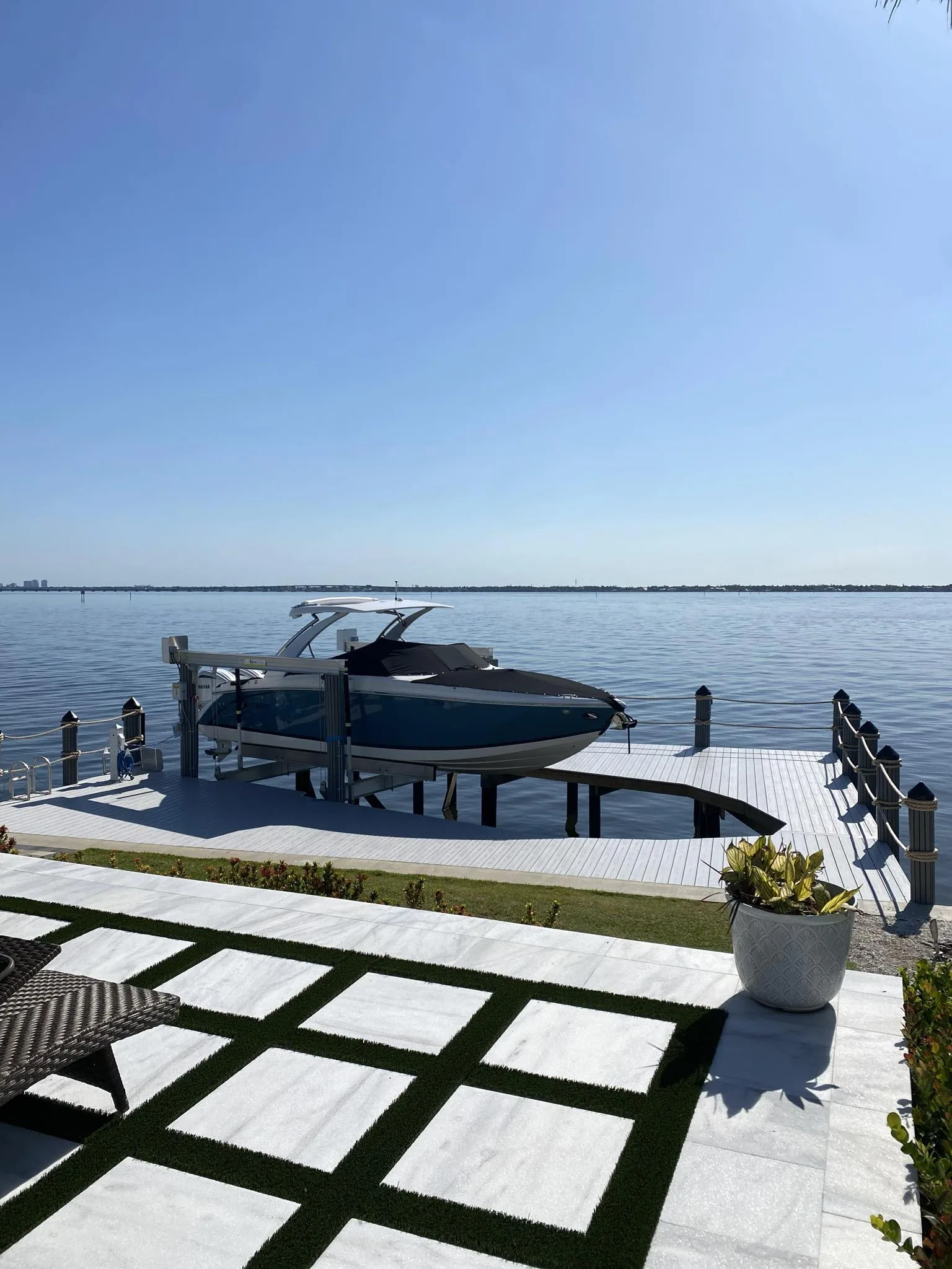 Boat lift installation beside a completed Top Notch Docks waterfront project