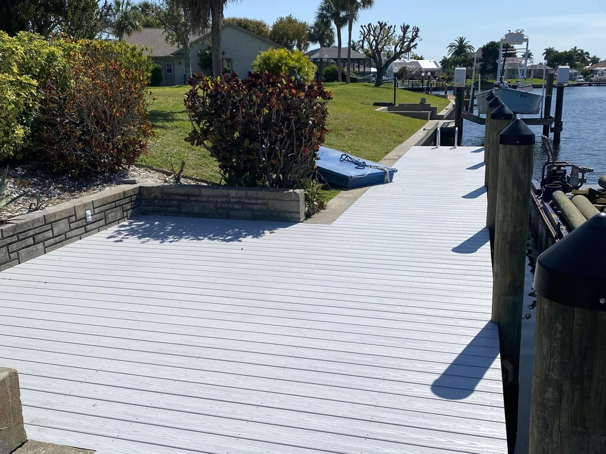 Cape Coral waterfront dock layout with boat lift beside a finished Top Notch Docks project