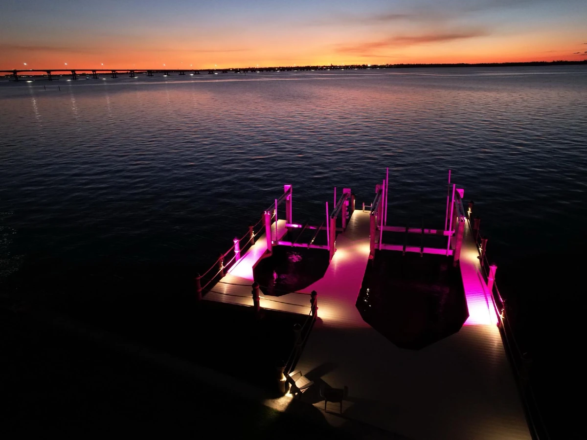 Finished waterfront boat lift layout at sunset on a Top Notch Docks project