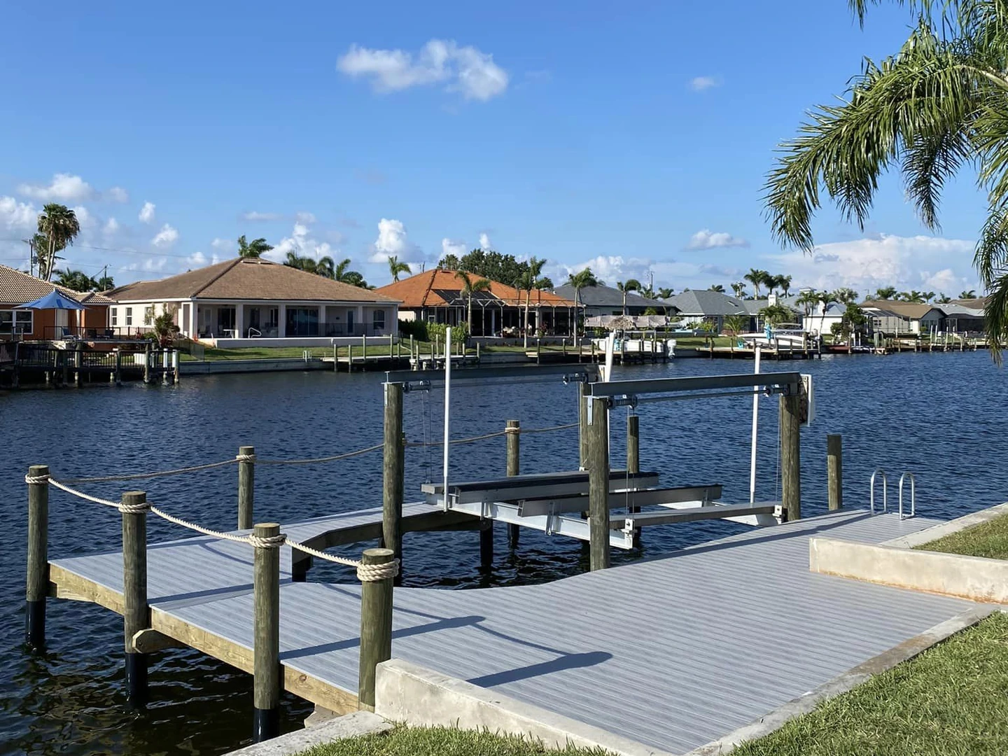 New boat lift integrated with a finished Cape Coral waterfront dock by Top Notch Docks