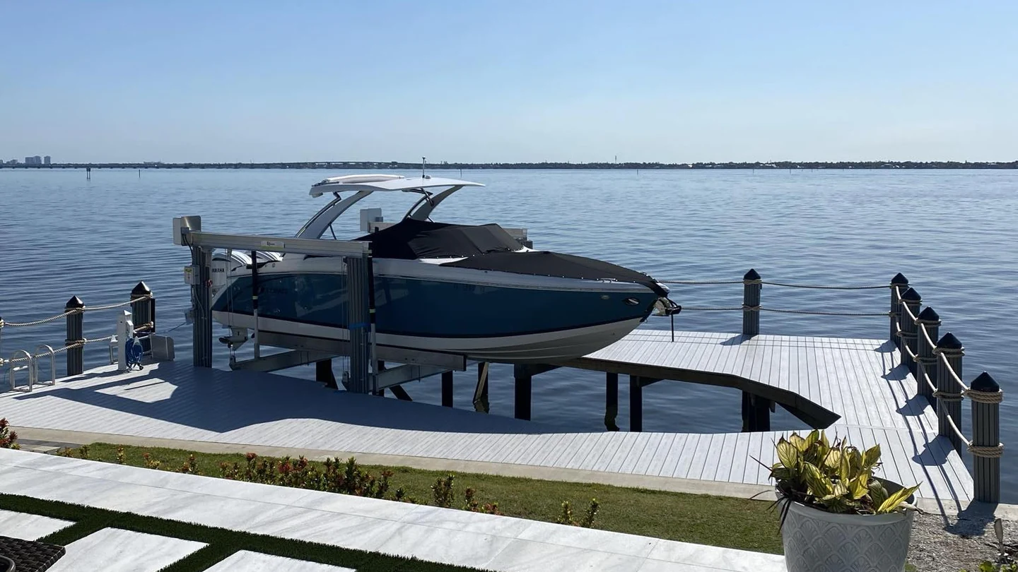 Boat lift and dock integration | Top Notch Docks Boat lift integrated with a waterfront dock project by Top Notch Docks