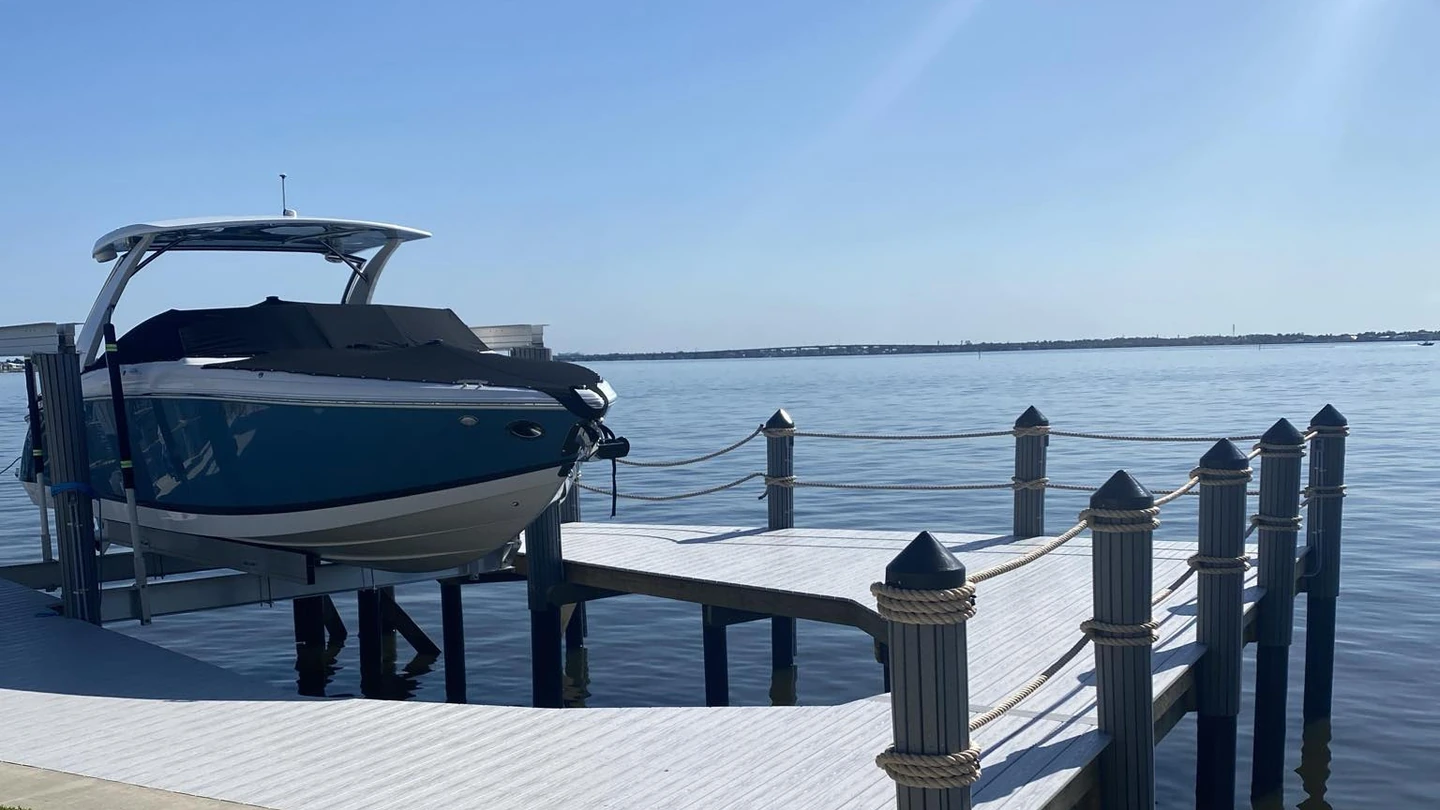 Finished dock and boat lift waterfront project | Top Notch Docks Finished Cape Coral waterfront dock and boat lift project by Top Notch Docks