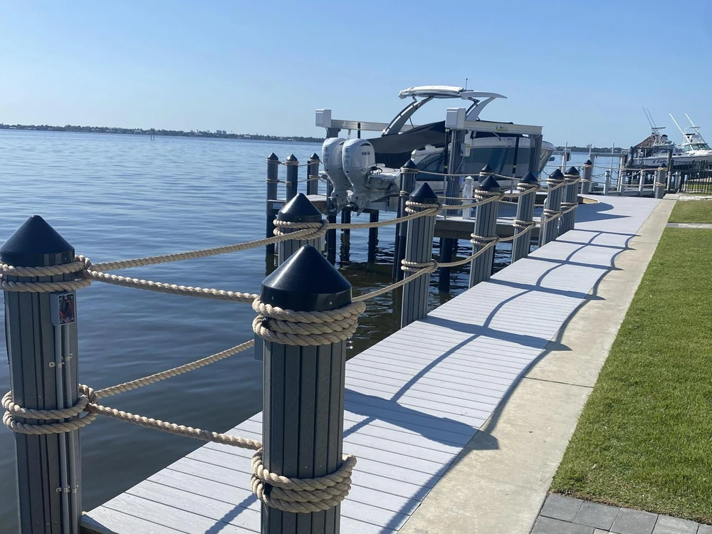 Finished dock walkway and boat lift | Top Notch Docks Finished dock walkway, rope railing, and boat lift by Top Notch Docks