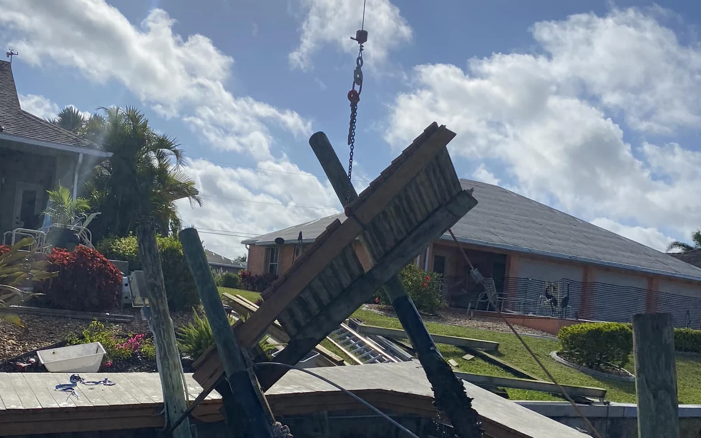 Cape Coral dock repair and storm damage evaluation | Top Notch Docks Storm-damaged dock structure being evaluated for repair at a Cape Coral waterfront property