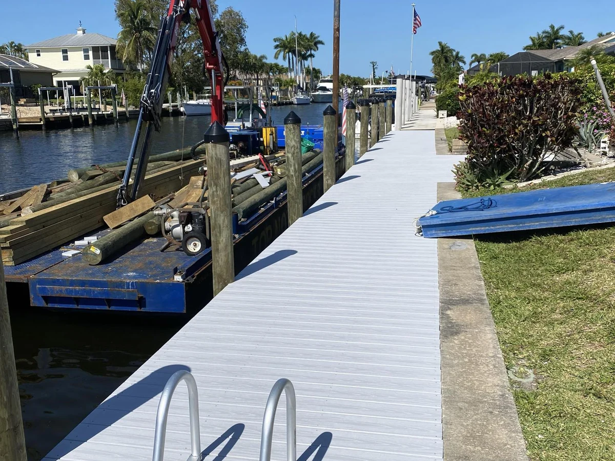 Top Notch Docks marine construction work beside a finished waterfront dock